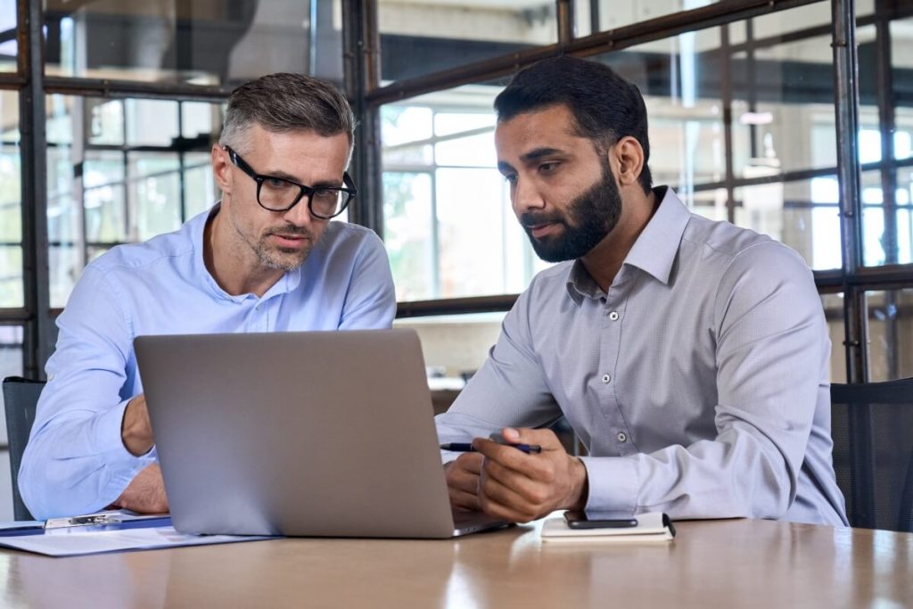 Two-business-men-analysts-discussing-data-management