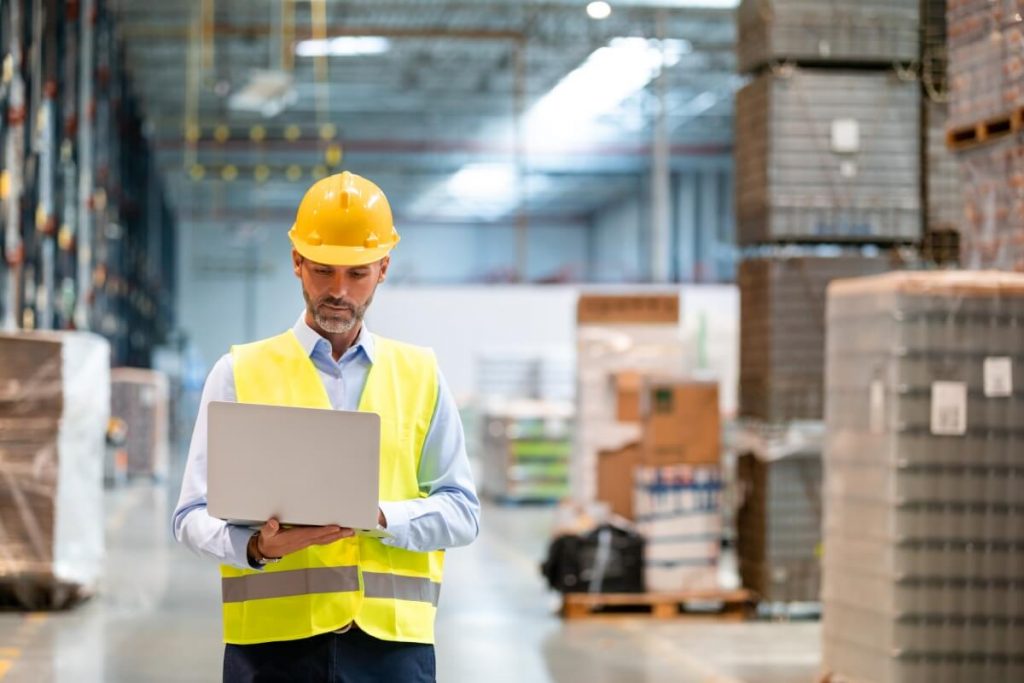 Warehouse-manager-with-laptop-entering-inventory